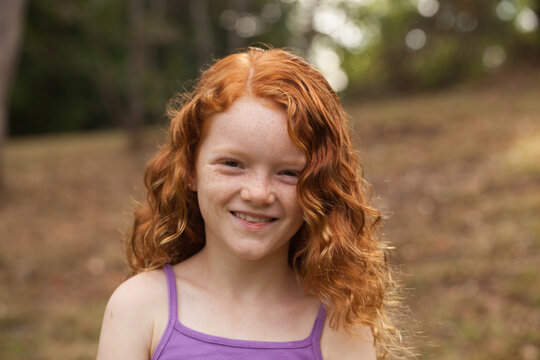 Young girl smiling in an open field