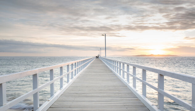 Fototapeta Long white pier at sunrise
