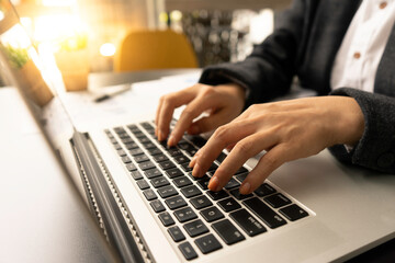Close up female hands typing on laptop keyboard, woman blogger working online, writing financial report, work form home concept.
