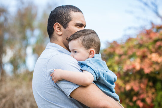 Father carrying his son while standing outdoors