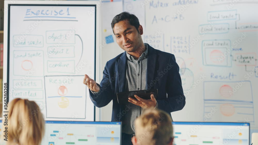 Poster elementary school class: teacher uses interactive digital whiteboard, explains lesson to diverse gro