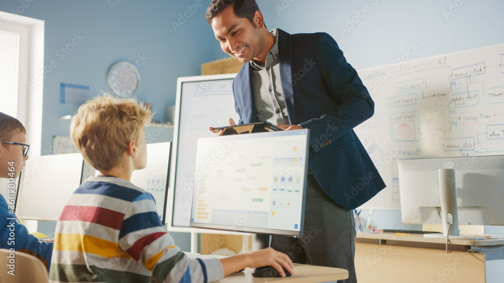 Poster elementary school computer science classroom: teacher uses tablet computer, explains lesson to diver