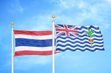 Thailand and British Indian Territory two flags on flagpoles and blue sky