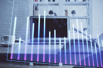 Stock market chart hologram drawn on personal computer background. Multi exposure. Concept of investment.