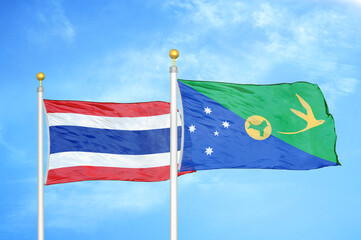 Thailand and Christmas Island two flags on flagpoles and blue sky