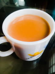 A Cup of milk tea placed in a table