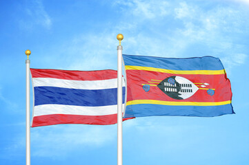 Thailand and Eswatini Swaziland two flags on flagpoles and blue sky
