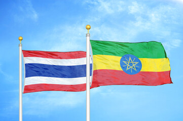 Thailand and Ethiopia two flags on flagpoles and blue sky