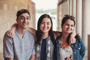 Happy multicultural students in library