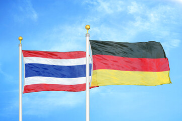 Thailand and Germany two flags on flagpoles and blue sky