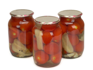 Canned and preserved tomatoes in glass jar isolated on white. Homemade pickled vegetables. Healthy fermented food.