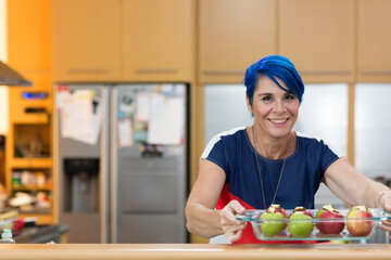 Woman with blue hair preparing apples for baking