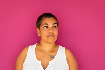 upper body of woman with very short hair against magenta backdrop