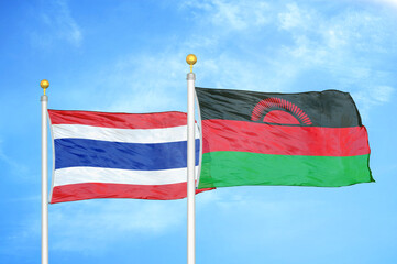 Thailand and Malawi two flags on flagpoles and blue sky
