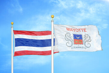 Thailand and Mayotte two flags on flagpoles and blue sky