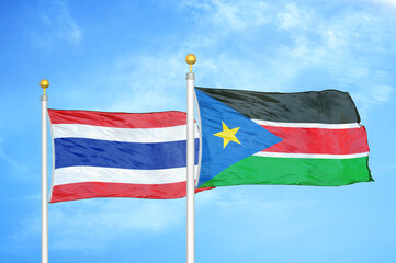 Thailand and South Sudan two flags on flagpoles and blue sky