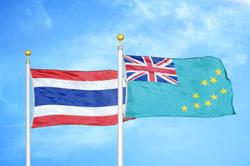 Thailand and Tuvalu two flags on flagpoles and blue sky