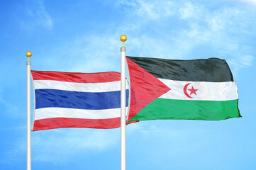 Thailand and Western Sahara two flags on flagpoles and blue sky