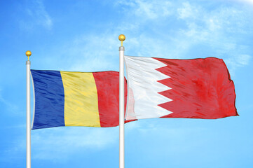 Romania and Bahrain two flags on flagpoles and blue sky