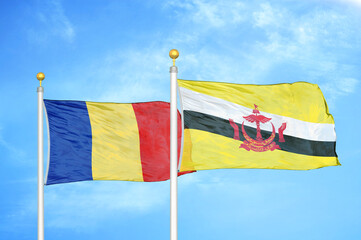 Romania and Brunei two flags on flagpoles and blue sky