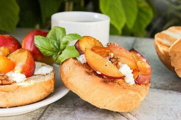 al fresco Breakfast of grilled bread rolls with goat fat, fruit, nuts, orange juice and coffee
