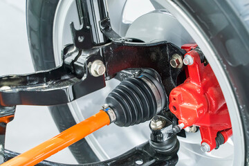 Elements of modern car front suspension. Control arm. Tie rod. Drive unit. Wheel bearing housing....