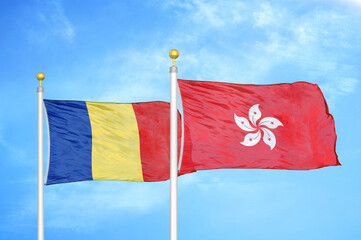 Romania and Hong Kong two flags on flagpoles and blue sky