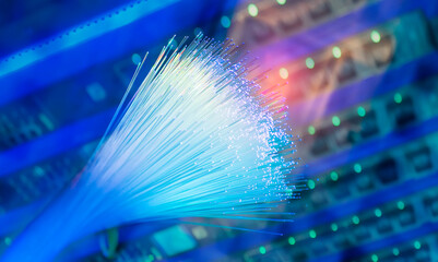 Fiber optics network cable on technology background