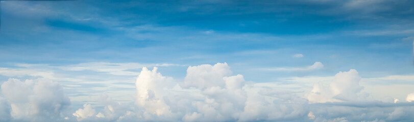 Beautiful blue sky with white fluffy clouds.