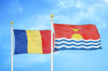 Romania and Kiribati two flags on flagpoles and blue sky