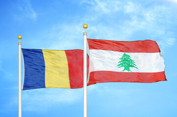 Romania and Lebanon two flags on flagpoles and blue sky