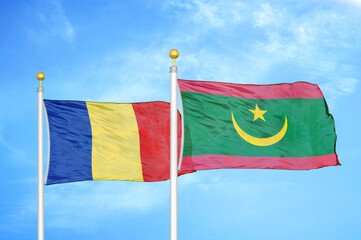 Romania and Mauritania two flags on flagpoles and blue sky
