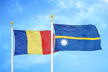Romania and Nauru two flags on flagpoles and blue sky