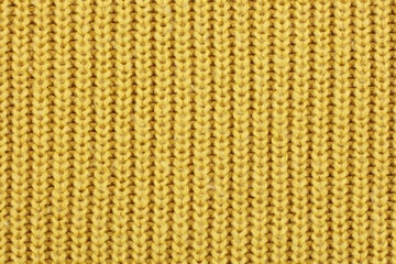 Yellow knitted ribbed wool textile background texture
