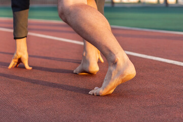 Athlete's legs on a treadmill without shoes