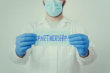 Writing note showing Partnership. Business concept for legal relation between two or more...