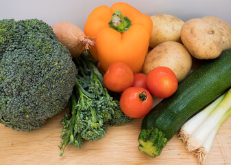 Fresh, healthy vegetables from a farmers market on a wooden chopping board