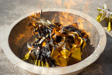 paper burning in metal bucket  to dead ancestors can receive and use in the afterlife