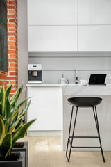 Black chair in white kitchen