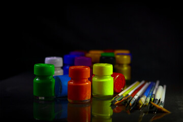 Multicolored Paint Bottles with Painting Brushes, Selective focus, selective focus on subject.
