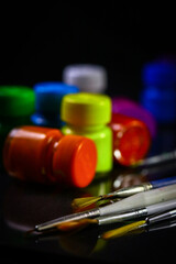 Multicolored Paint Bottles with Painting Brushes, Selective focus, selective focus on subject.