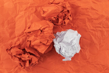 The colored paper is heavily crumpled on a crumpled paper background of red