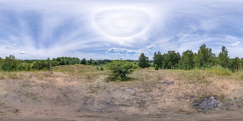 Full spherical seamless panorama 360 degrees angle view on high hill among fields and bushes with clear sky with halo in equirectangular projection, VR AR content