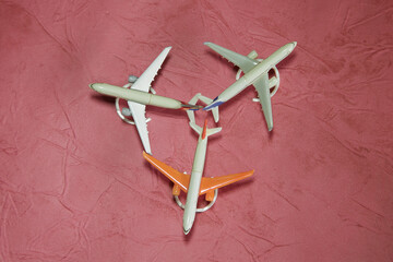 toy planes on a pink matte background