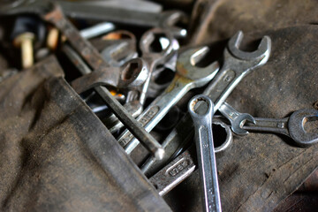 Obraz na płótnie Canvas Rusty iron carob keys on a table in the garage