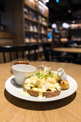 Substantial breakfast with fried egg, salad, bread and coffee, top view