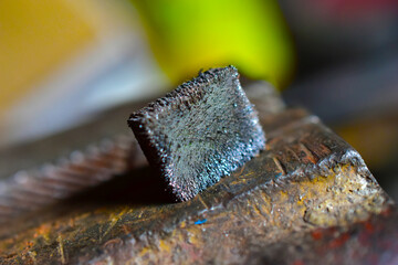 Metal magnet in the iron crumb in the hands