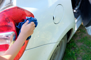 hand with car wash. self-service car wash.  home car wash.  rag in hand