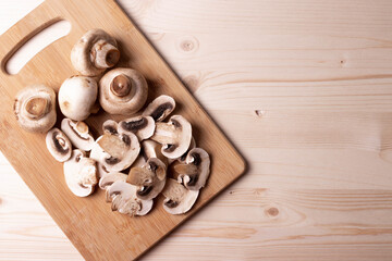 Fototapeta na wymiar raw champignon mushrooms on wooden surface