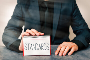 Conceptual hand writing showing Standards. Concept meaning something established by authority,...